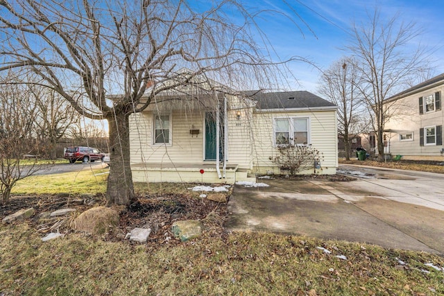 bungalow-style home featuring roof with shingles