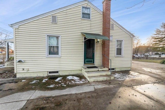 view of front of property featuring a chimney