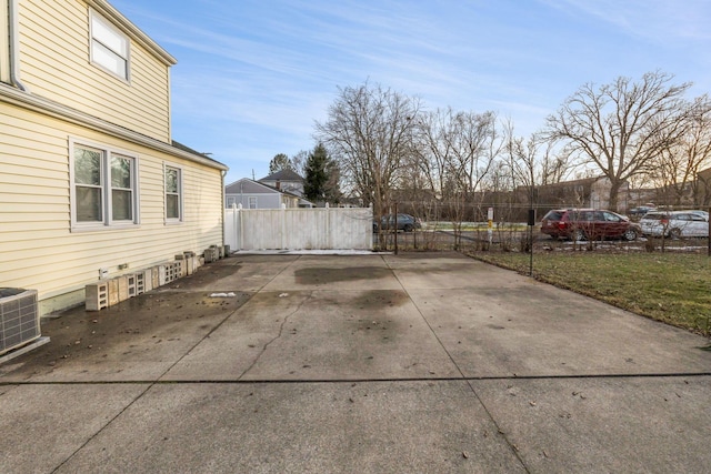 view of patio with fence and cooling unit