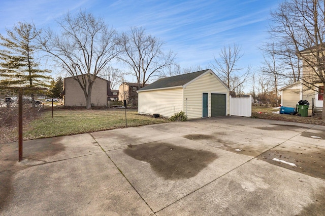 detached garage with driveway and fence