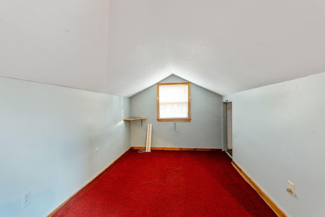 bonus room featuring carpet floors, vaulted ceiling, and baseboards