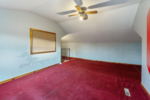 additional living space featuring carpet, visible vents, vaulted ceiling, and baseboards