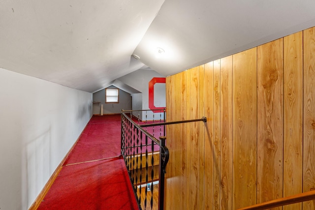 additional living space featuring vaulted ceiling and dark carpet