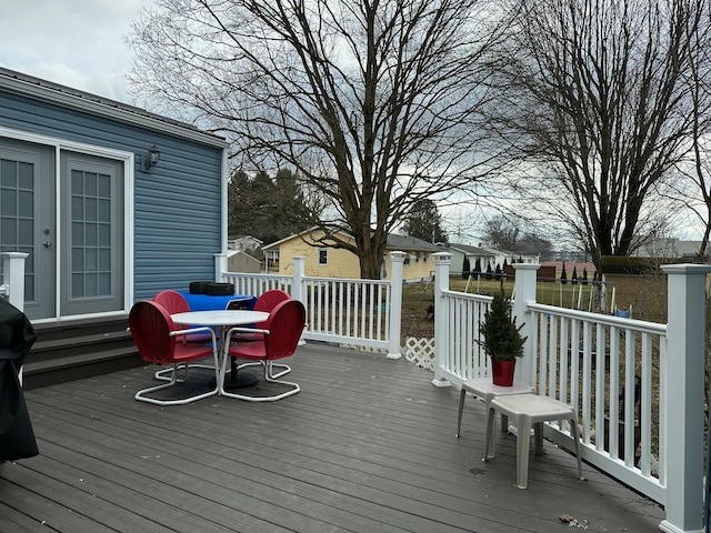 wooden terrace with outdoor dining space