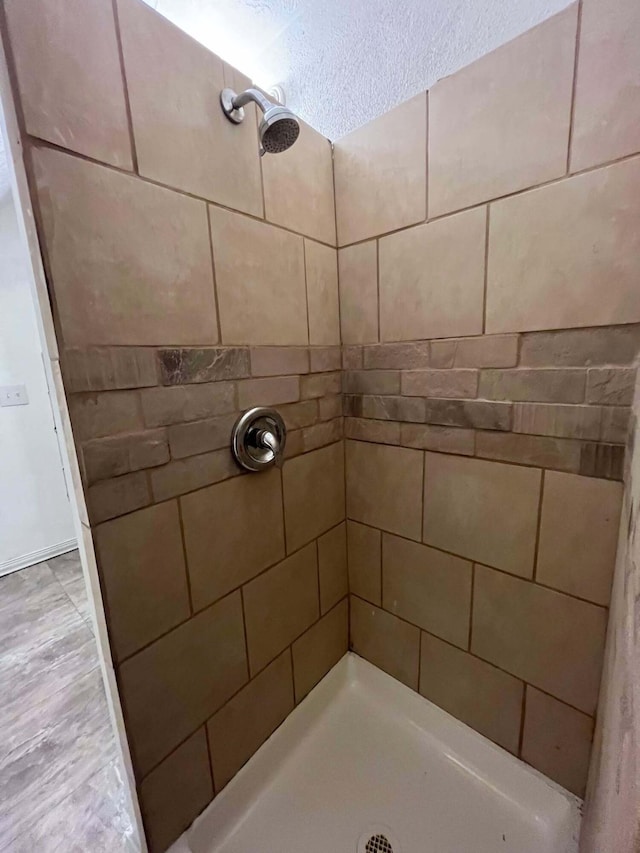 full bath featuring tiled shower