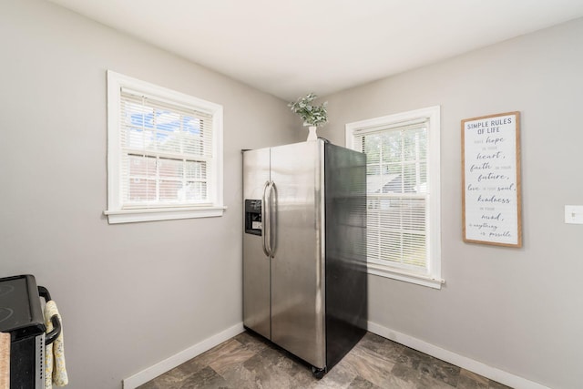1724 E Livingston Ave, Columbus, OH 43205 - kitchen featuring stainless steel fridge with ice dispenser, baseboards, and healthy amount of natural light