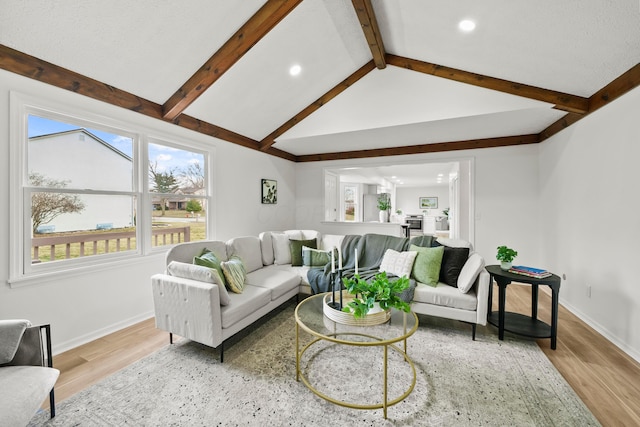 living area with lofted ceiling with beams, light wood-style flooring, baseboards, and recessed lighting