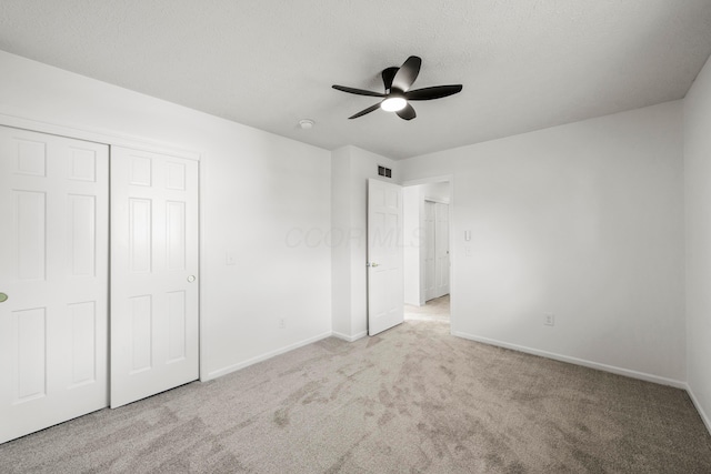 unfurnished bedroom with light colored carpet, visible vents, and baseboards