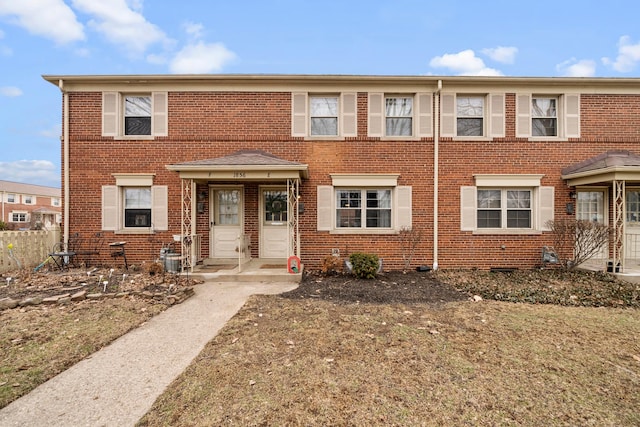 townhome / multi-family property with brick siding