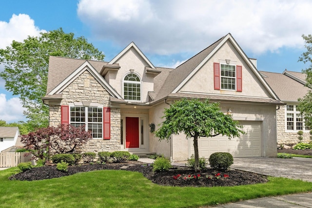 6266 Misty Cove Ln, Columbus, OH 43231 - traditional home with stone siding, stucco siding, driveway, and an attached garage