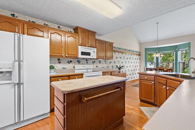 6266 Misty Cove Ln, Columbus, OH 43231 - kitchen with white appliances, a sink, lofted ceiling, light wood-style flooring, and a kitchen island