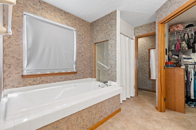 6266 Misty Cove Ln, Columbus, OH 43231 - bathroom with a walk in closet, a garden tub, a shower with curtain, and wallpapered walls