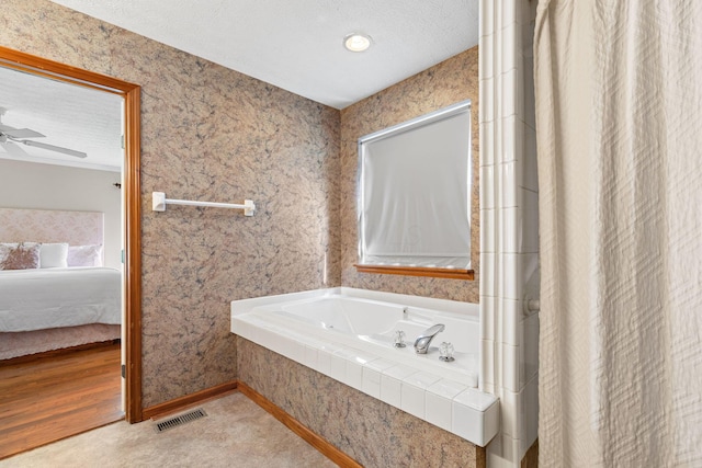 6266 Misty Cove Ln, Columbus, OH 43231 - ensuite bathroom with a tub with jets, ceiling fan, and a textured ceiling