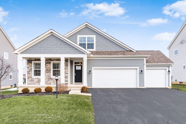 view of front facade featuring a garage, roof with shingles, aphalt driveway, and a front lawn