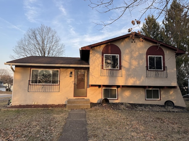 tri-level home with stucco siding