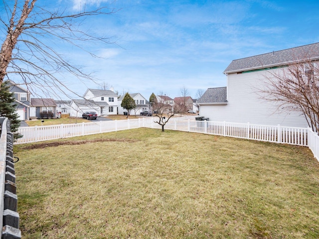 view of yard featuring a fenced backyard and a residential view