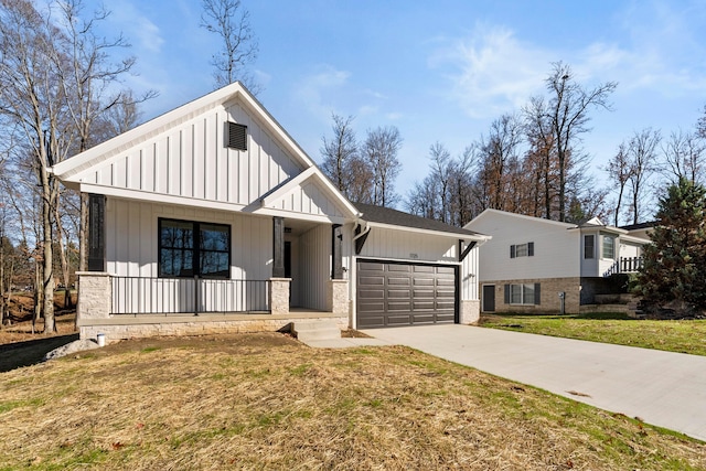 modern inspired farmhouse featuring covered porch, concrete driveway, board and batten siding, a front yard, and a garage