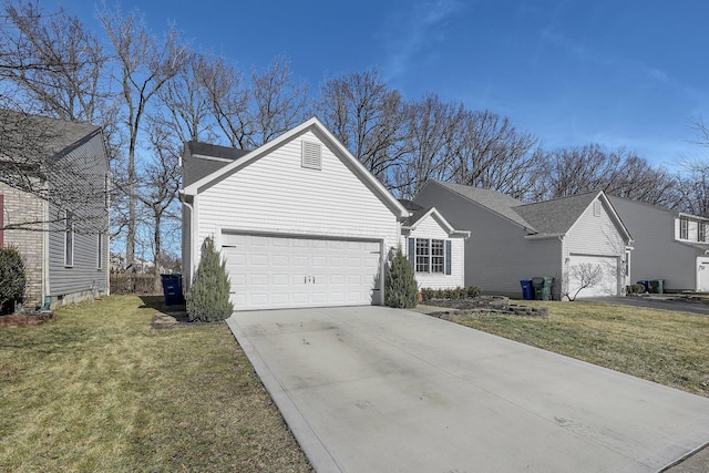 view of front of home with a garage, driveway, and a front lawn