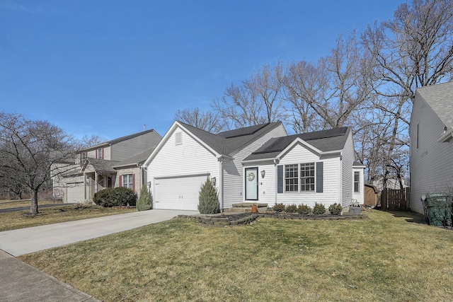 view of front of home featuring a front lawn, driveway, and an attached garage