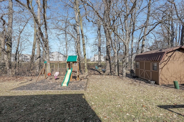 view of playground with a storage shed and an outbuilding