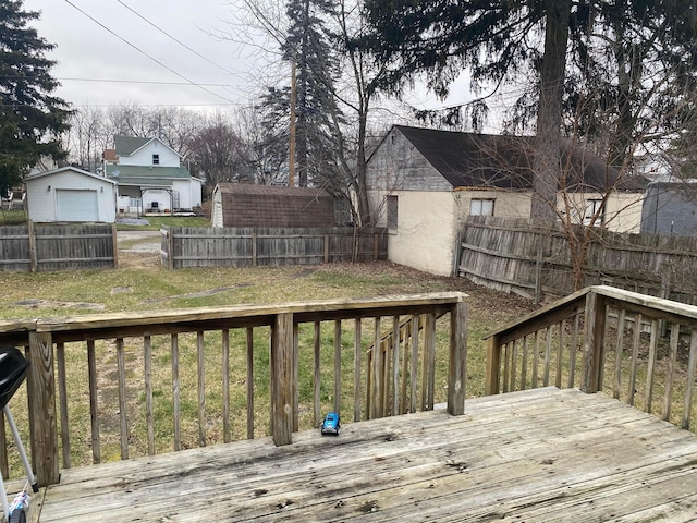 wooden terrace featuring a fenced backyard and a yard