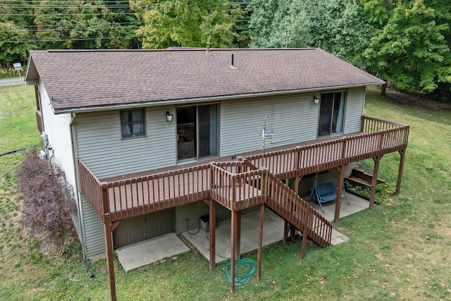 back of house featuring a lawn, a deck, stairs, and a shingled roof