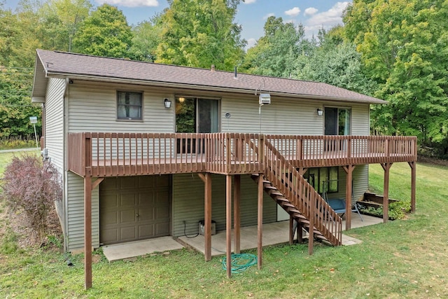 back of property featuring an attached garage, stairs, a deck, a patio area, and a lawn