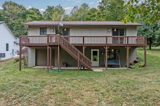 rear view of property with a deck, a patio, a lawn, and a garage