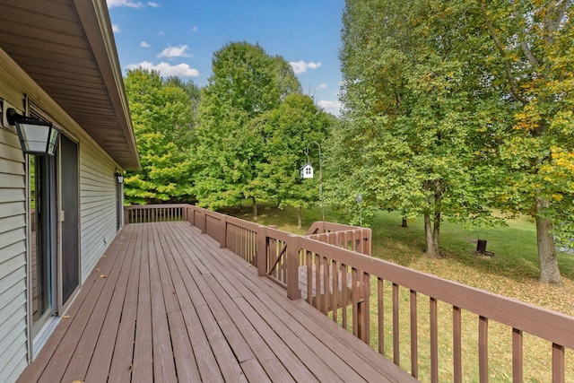 wooden terrace with a lawn