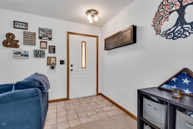 entrance foyer with baseboards and light tile patterned flooring