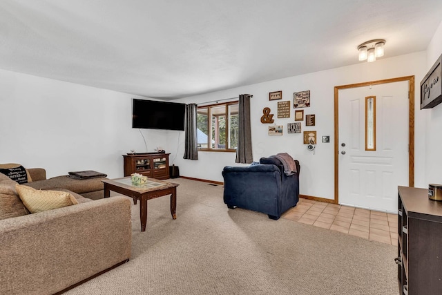 living area with baseboards, light carpet, and light tile patterned flooring