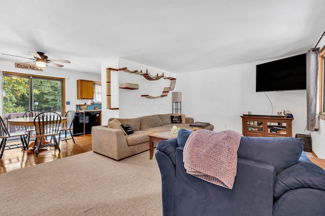 living room with light colored carpet and ceiling fan