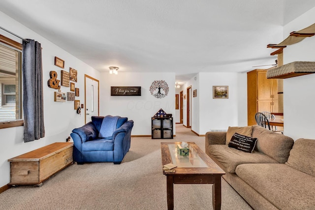 living room featuring light colored carpet and baseboards