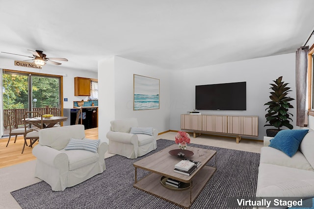 living room with baseboards and ceiling fan