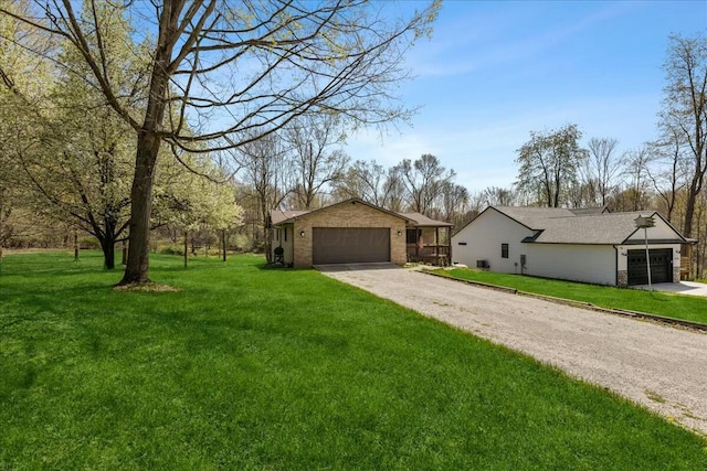 14580 Monroe Mills Rd, Mount Vernon, OH 43050 - single story home with brick siding, a front lawn, driveway, and a garage