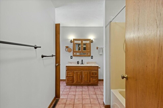 14580 Monroe Mills Rd, Mount Vernon, OH 43050 - full bathroom with baseboards, vanity, and tile patterned floors