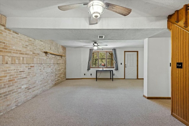14580 Monroe Mills Rd, Mount Vernon, OH 43050 - interior space with a ceiling fan, a textured ceiling, brick wall, baseboards, and visible vents