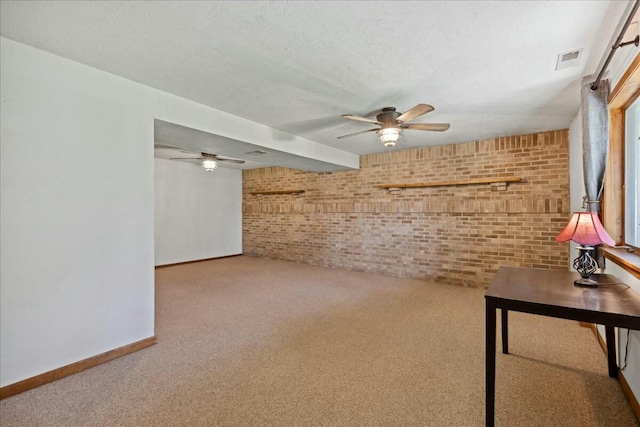 14580 Monroe Mills Rd, Mount Vernon, OH 43050 - interior space featuring a ceiling fan, brick wall, carpet, baseboards, and visible vents