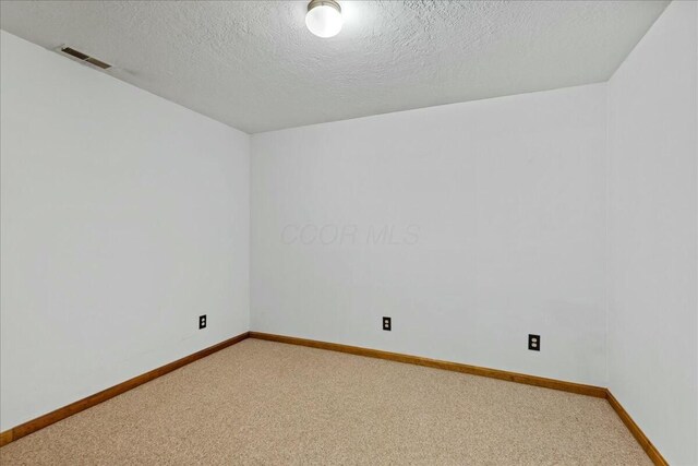 14580 Monroe Mills Rd, Mount Vernon, OH 43050 - spare room with a textured ceiling, baseboards, visible vents, and light colored carpet