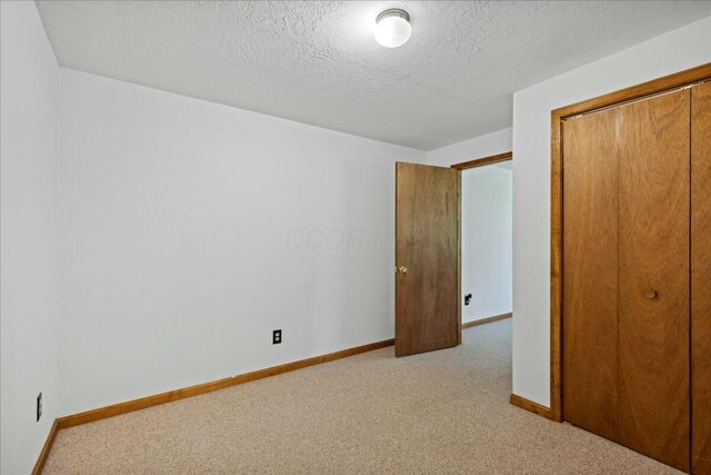 14580 Monroe Mills Rd, Mount Vernon, OH 43050 - unfurnished bedroom featuring light colored carpet, baseboards, and a closet