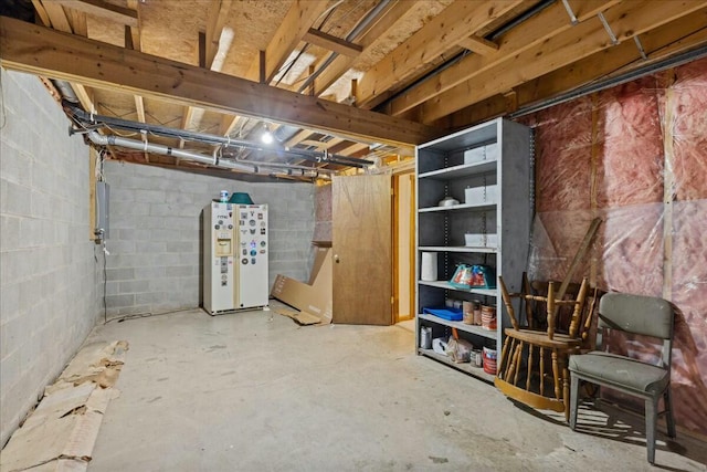 14580 Monroe Mills Rd, Mount Vernon, OH 43050 - unfinished below grade area with electric panel, concrete block wall, and white fridge with ice dispenser