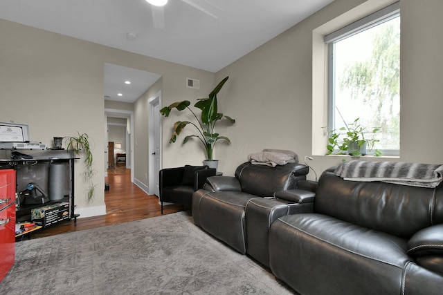 living area with recessed lighting, wood finished floors, a ceiling fan, visible vents, and baseboards