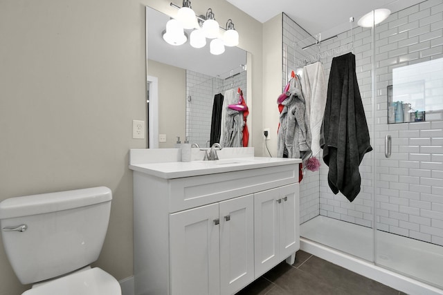 bathroom featuring vanity, a stall shower, tile patterned flooring, and toilet