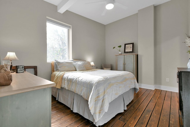 bedroom with a ceiling fan, wood-type flooring, beam ceiling, and baseboards