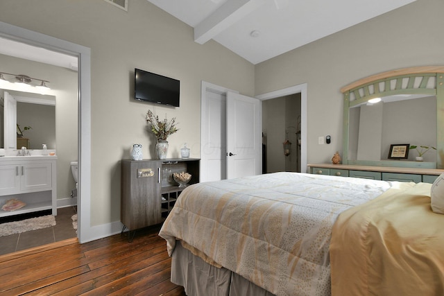 bedroom with lofted ceiling with beams, ensuite bathroom, dark wood-type flooring, a sink, and baseboards