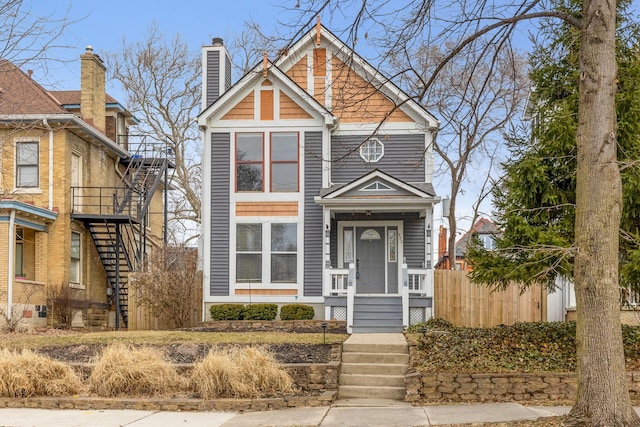 view of front of home with fence and stairs