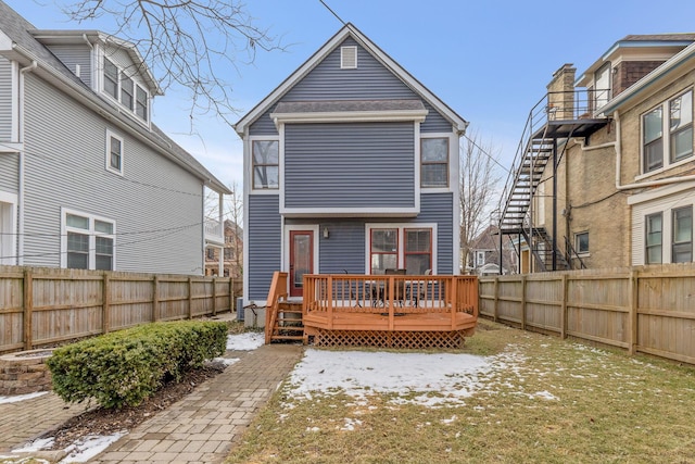 rear view of property featuring a fenced backyard, stairs, and a wooden deck