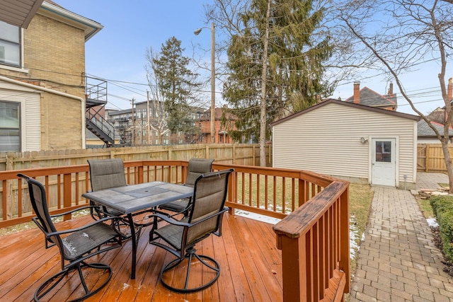 wooden terrace with outdoor dining area and fence