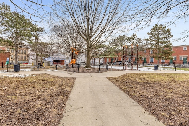 view of home's community with fence and playground community