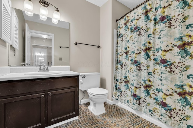 bathroom with baseboards, toilet, a shower with curtain, tile patterned flooring, and vanity